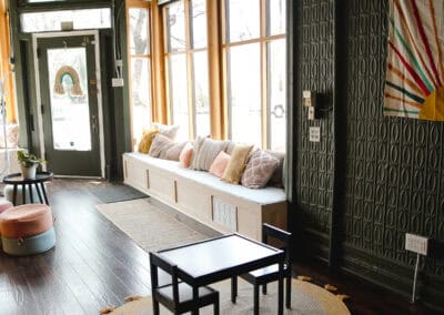 Cozy chiropractic office with large windows, comfortable seating, and stylish decor.