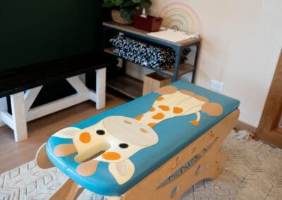 Pediatric chiropractic adjustment table with playful animal design for children.